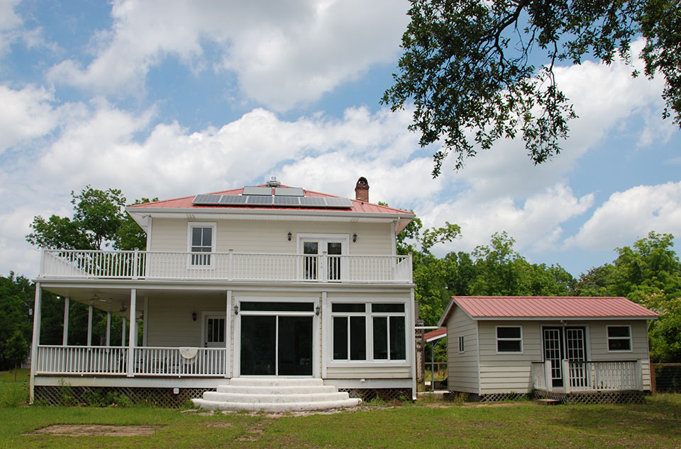 Picture of a Two-Story Home with a Solar Panel on Roof